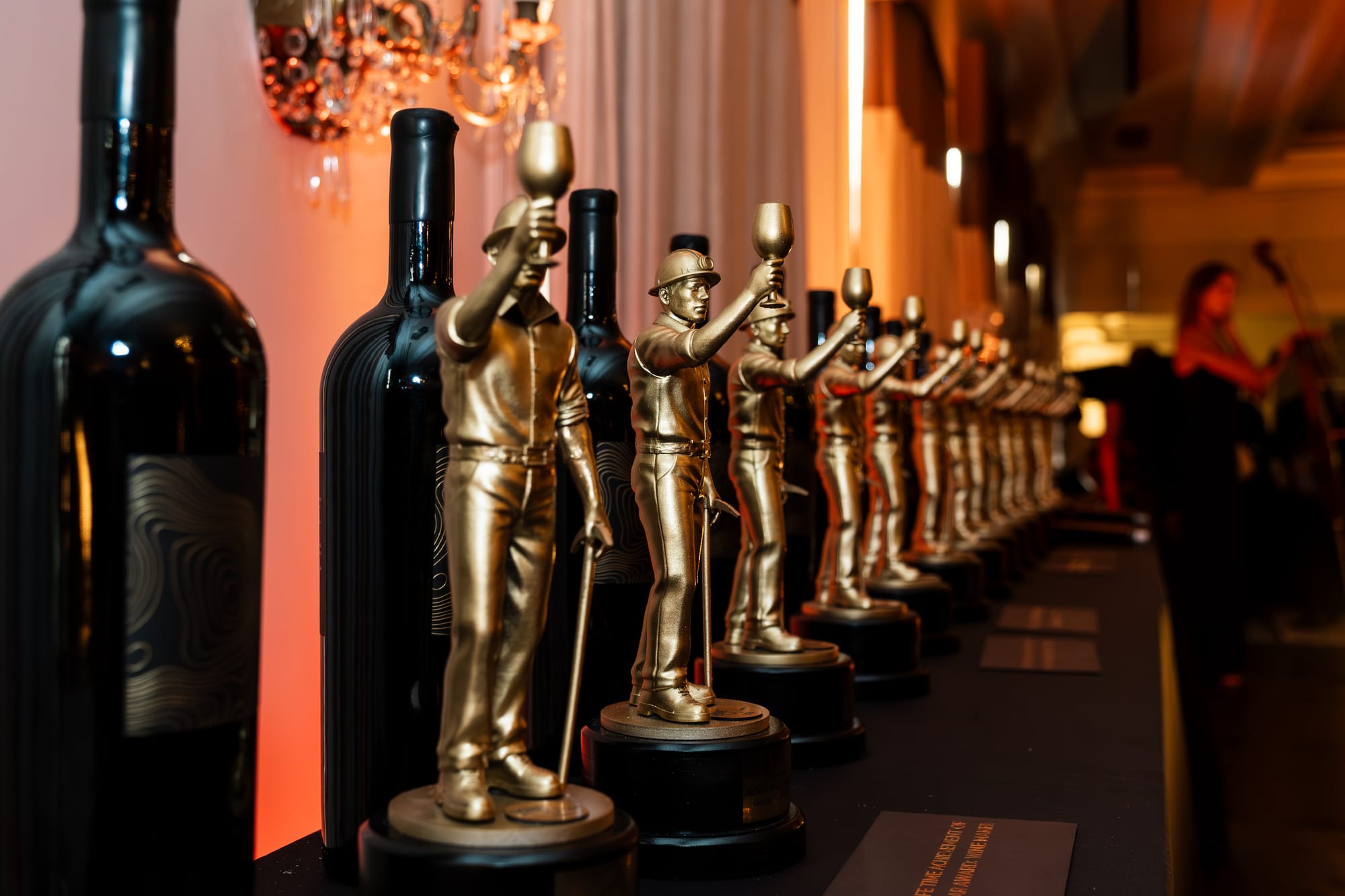 The Mine & Wine award statuettes lined up beside magnums before the ceremony